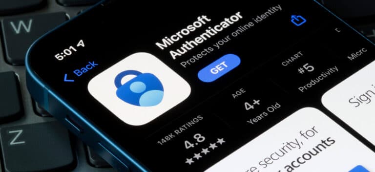 A smartphone screen displays the Microsoft Authenticator app page in the App Store, showing the app icon, rating, age restriction, and the blue "GET" button, with part of a keyboard visible underneath.